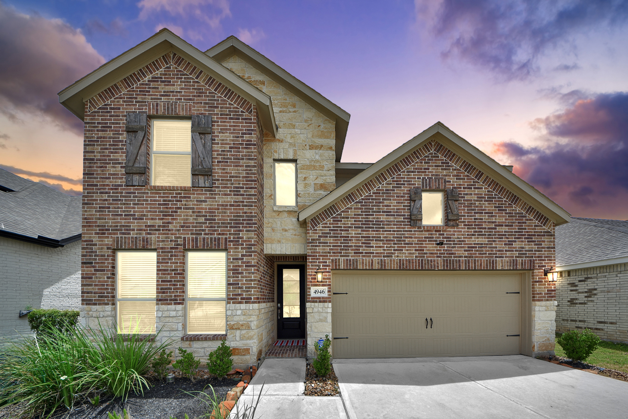 4946 Sky Bluff Dr twilight front exterior in Sunterra Katy TX